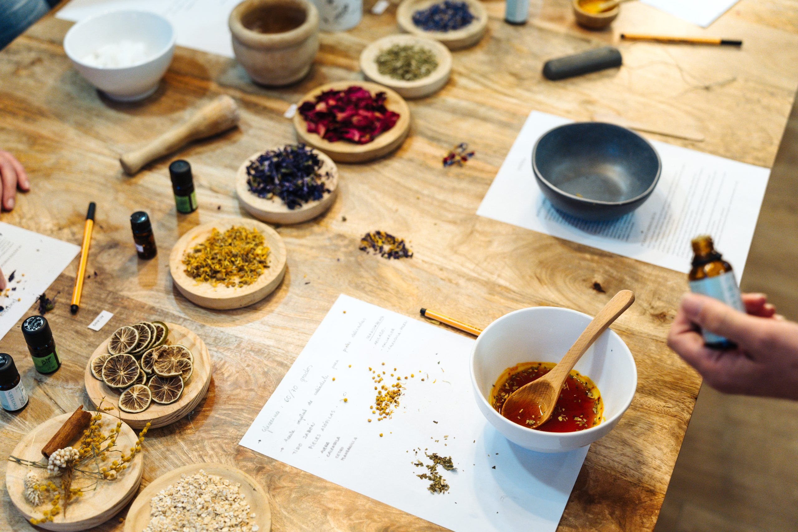 Women mixing ingredients to create natural handmade soaps